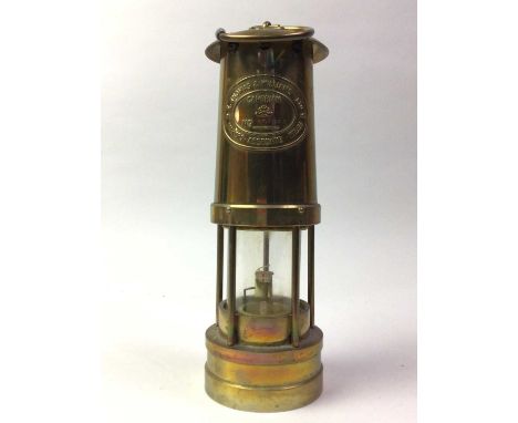THREE BRASS MINERS LAMPS, the larger by E. Thomas &amp; Williams Ltd of Aberdare, Wales, along with a smaller example, by Pro