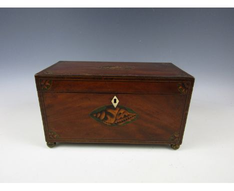 A George III marquetry-inlaid mahogany tea caddy, of rectangular section, string-inlaid, cross-banded and bearing inlaid shel
