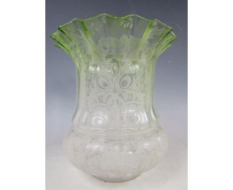 A late Victorian achromatizing green and acid etched glass oil lamp shade, incorporating stylized holly leaves and floral spr