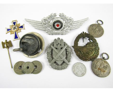 A group of German Third Reich military medals and insignia comprising a Kriegsmarine destroyer war badge (pin lacking), a Mot