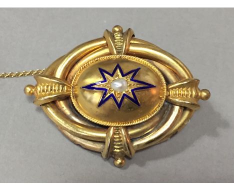 A Victorian yellow-metal concealed locket brooch, with central oval domed face surmounted by a blue enamelled star and single