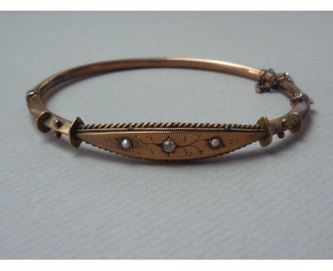 A Victorian diamond- and pearl-set 9ct rose gold bracelet, of hollow rounded triangular section and having a lenticular face,