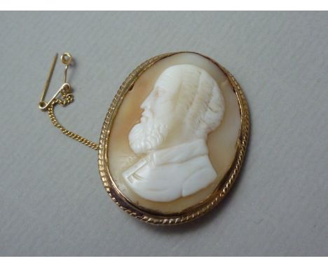 A shell cameo brooch, carved with the profile portrait of a gentleman, rub set in a yellow metal frame 