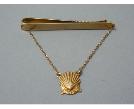 A gentleman's long service award 9ct gold tie clip, with dependent shell medallion, 9.8g