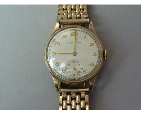 A 1950s Movado 9ct gold wrist watch, having a 15 jewel manual-wind movement, and silvered face with raised gilt Arabic numera