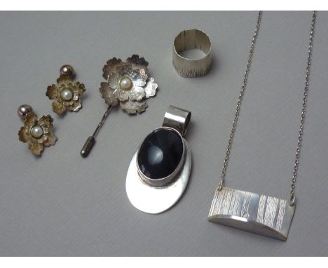 A Mexican white metal pendant rub-set with a cabochon stone, marked 925 (tests as silver), together with a handcrafted white 