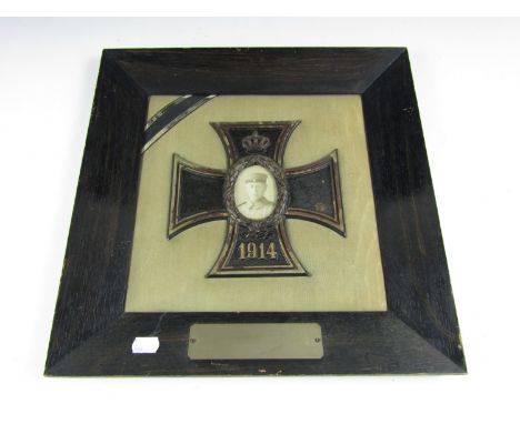 An Imperial German War service memorial plaque, comprising a finely cast representation of a 1914 Iron Cross centred by a lau