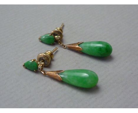 A pair of 1930s jade pendant earrings, each having a pear-shaped cabochon stud earring above a conforming dependent drop, mou