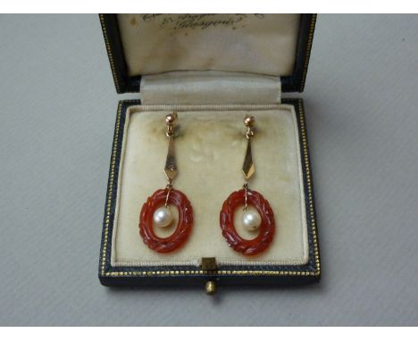 A pair of late Victorian / early Edwardian carnelian and pearl ear pendants, each with an inverted kite shaped suspender abov