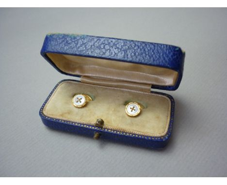 An early 20th Century gentleman's cased pair of 9ct gold and mother of pearl dress studs in the form of a stitched button