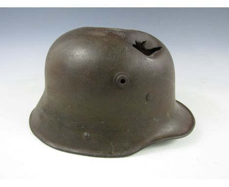 A shrapnel damaged Imperial German M' 1916 steel helmet 