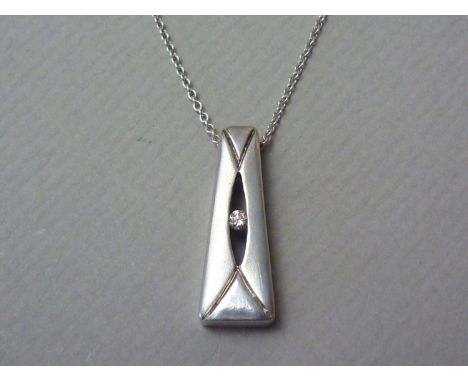 A contemporary diamond and white metal pendant necklace, of tapering rectangular form, curvilinear engraved and centrally ret