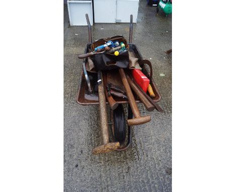 A wheelbarrow and tools