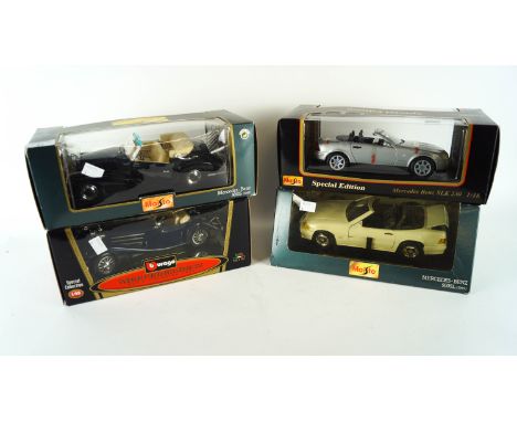 A collection of four 1:18 scale die cast model cars