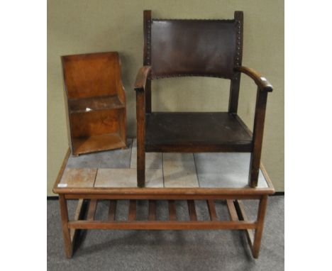 A tile top coffee table together with a Deco chair and a bookcase