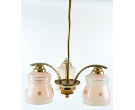 A 1930's three branch ceiling light, each pink glass light shade printed with a flower sprig, 53cm drop