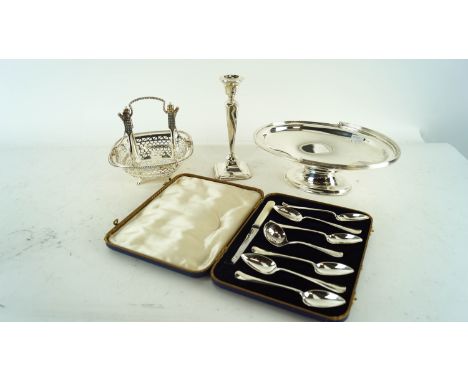 A silver candlestick and other silver plate