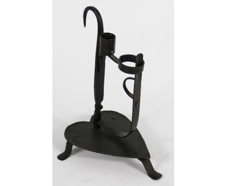 An Arts and Crafts wrought iron combination light and candlestick, on heart shaped base, 23cm