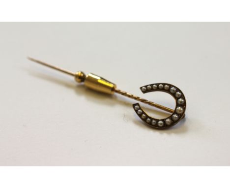 A split seed pearl set horseshoe stick pin, the yellow gold stick pin set with graduated split seed pearls stamped 'ORR 15', 