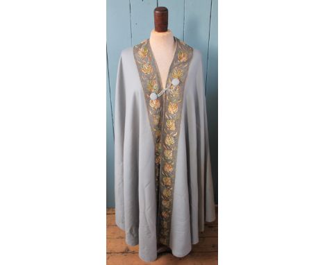 A Liberty and Co pale blue wool cloak, with floral trim, original label