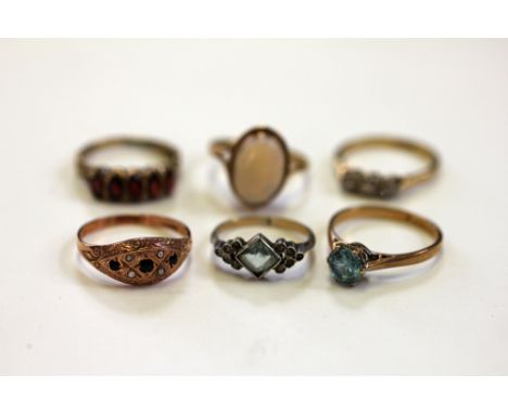 Six rings, to include; A zircon set solitaire ring, a paste set ring stamped '9ct & Sil', an opal set ring, a three stone dia