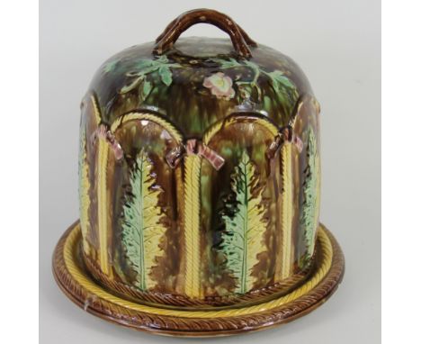 A 19th century continental majolica cheese bell and base, moulded with ferns and flowers, 27cm