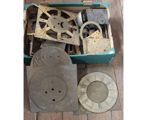 An assortment of 18th century and later clock parts and movements, to include a chapter ring signed John Swinburn Hexham and 