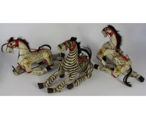 A carved and painted wood Zebra puppet; with a pair of horse puppets painted with flowers, 20cm