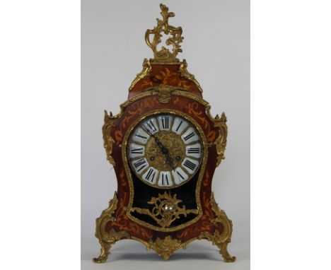 A Louis XV style marquetry inlaid mantel clock, brass dial with enamel Roman numerals and movement striking on two bells, mov