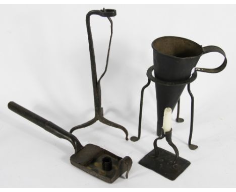 An 18th century wrought iron rush nip light; a combination chamberstick and vesta case; a smaller candlestick and a warmer wi