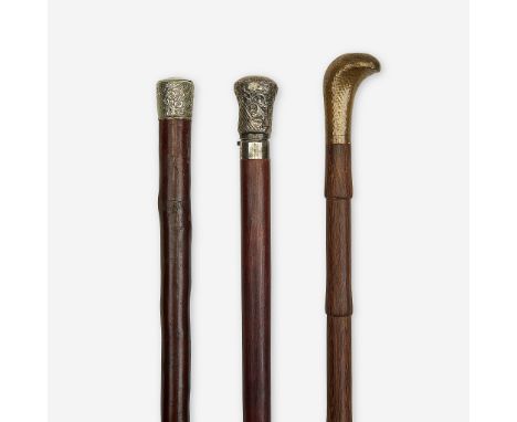 A group of three light canes Various dates late 19th/20th century Comprising a silver and hardwood light bulb cane, the relea