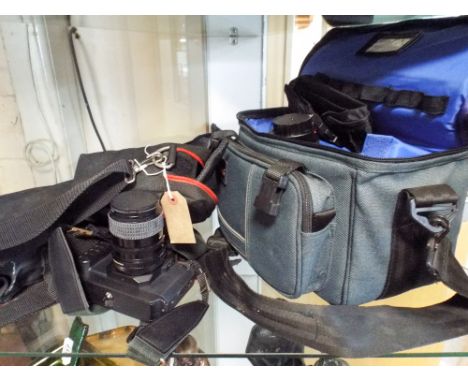 A Cannon T80 35mm camera with telephoto lenses, tripod, carrying bag etc 
