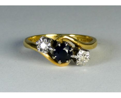 Three stone sapphire and diamond ring, set in a cross-over design on 18ct yellow gold shank, ring size M