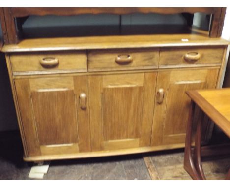 An Ercol light oak sideboard fitted three drawers and three cupboards, 3' wide 