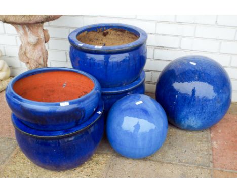 Four large blue ceramic garden pots and two large blue globe shaped garden ornaments 