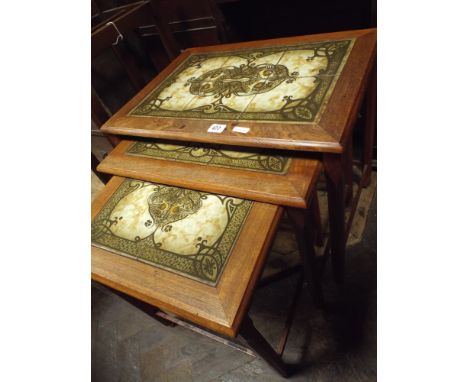 A nest of three Danish teak coffee tables with inset tile tops 