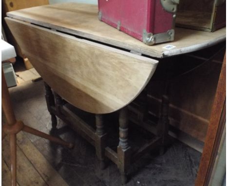 A stripped oak gate legged table, about 3'9" wide 