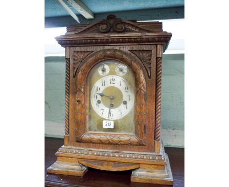 A late Victorian chiming bracket clock in carved oak case with brass and silver dial, overall height 19", 14" wide 
