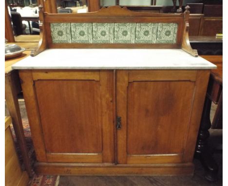 An Edwardian satin walnut washstand with white marble top, green tile back and two door cupboard under, 3'6" wide 