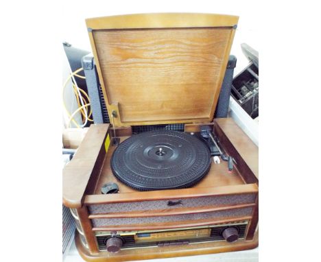 A radio, CV player with record deck in an antique style wooden case 