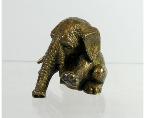 A silver miniature model of a seated baby elephant balancing on his trunk, 92 grams. London hallmarks  No sign of damage or r