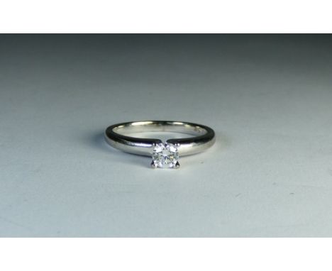 An 18ct white gold solitaire diamond ring set with a circular brilliant cut diamond weighing 0.33ct, ring size M 