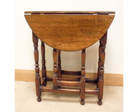 A late 19th early 20th century oval gate legged table on turned legs with cross stretchers, 2' wide 