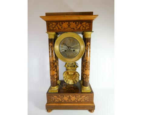 A Regency inlaid rosewood portico clock with brass bezel, gilt metal mounts and ornate shell shaped pendulum, height 50cm 