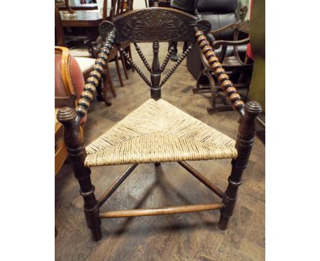 A 19th Century oak bobbin turned, corner style chair with rush seat 