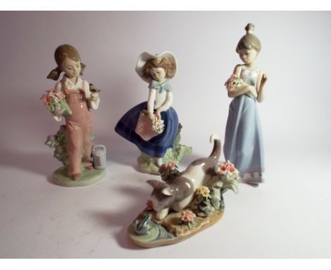 A collection of four Lladro porcelain figurines three girls holding bouquets and one of a kitten playing with a frog 