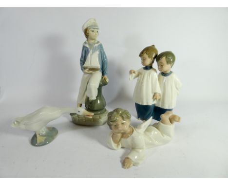 A collection of four Lladro and Nao figurines the largest of which measures 24cm 