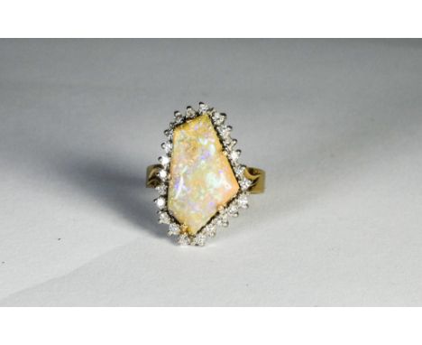 A contemporary boulder opal and diamond cluster ring on a 14ct yellow gold band, ring size M 