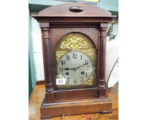 An Edwardian bracket clock with striking movement, brass and silver dial in walnut case