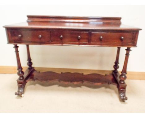 A Victorian mahogany side table fitted three draws with under tier, standing on turned legs with carved feet, 4' wide